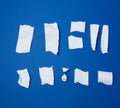 Set of various pieces of torn white crumpled paper on a blue background Royalty Free Stock Photo