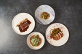 Set of various plates of food on a gray table background with copy space Royalty Free Stock Photo