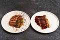 Set of various plates of food on a gray table background with copy space Royalty Free Stock Photo