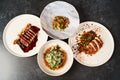 Set of various plates of food on a gray table background with copy space Royalty Free Stock Photo