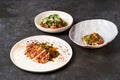 Set of various plates of food on a gray table background with copy space Royalty Free Stock Photo