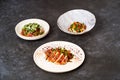 Set of various plates of food on a gray table background with copy space Royalty Free Stock Photo