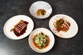 Set of various plates of food on a gray table background with copy space Royalty Free Stock Photo