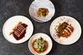 Set of various plates of food on a gray table background with copy space Royalty Free Stock Photo