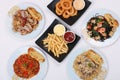 set of various plates of food, pasta dishes, onion ring, french fried, isolated on white background, top view. Royalty Free Stock Photo