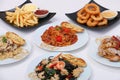 set of various plates of food, pasta dishes, onion ring, french fried, isolated on white background, top view. Royalty Free Stock Photo