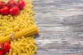 Set various raw ingredients for cooking Italian pasta on gray table, top view Royalty Free Stock Photo