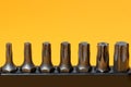 A set of various screwdriver bits on yellow background Royalty Free Stock Photo
