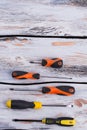 Set of various screwdrivers on wooden background.