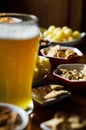 Set of various snacks, pint of lager beer in a glass, a standard set of drinking and eating in a pub Royalty Free Stock Photo