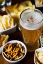 Set of various snacks, pint of lager beer in a glass, a standard set of drinking and eating in a pub Royalty Free Stock Photo