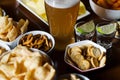 Set of various snacks, pint of lager beer in a glass, a standard set of drinking and eating in a pub Royalty Free Stock Photo