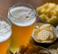 Set of various snacks, pint of lager beer in a glass, a standard set of drinking and eating in a pub