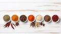 Set of various spices in a bowls on white wooden table background, border with copy space Royalty Free Stock Photo