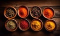 Set of various spices, cardamom, paprika, peppers, garlic, turmeric in bamboo bowls on a dark wooden background