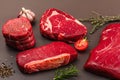 Set of various steaks with classic spices and herbs. Ribeye, eye round, flank and striploin steaks