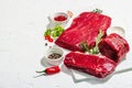 Set of various steaks with spices and herbs. Eye round, flank and striploin steaks Royalty Free Stock Photo