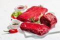 Set of various steaks with spices and herbs. Eye round, flank and striploin steaks Royalty Free Stock Photo