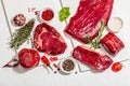 Set of various steaks with spices and herbs. Ribeye, eye round, flank and striploin steaks Royalty Free Stock Photo