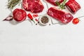 Set of various steaks with spices and herbs. Ribeye, eye round, flank and striploin steaks Royalty Free Stock Photo