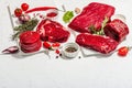 Set of various steaks with spices and herbs. Ribeye, eye round, flank and striploin steaks Royalty Free Stock Photo