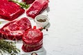 Set of various steaks with spices and herbs. Ribeye, eye round, flank and striploin steaks Royalty Free Stock Photo