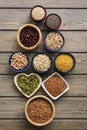 A set of various superfoods , whole grains,beans, seeds, legumes in bowls on a wooden plank table. Top view, copy space Royalty Free Stock Photo