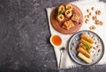 Set of various traditional arabic sweets: baklava, kunafa, basbus in  ceramic plates on a black concrete background. top view Royalty Free Stock Photo