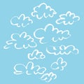 Set of various unique clouds on blue background. Hand drawn clouds. Marker stroke sky.