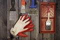 Set of various working painting tools - spatulas, brush, tray and work gloves on a dark wooden background with copy space Royalty Free Stock Photo