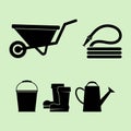 Set of vector illustrations of silhouettes of garden wheelbarrow, hose, rubber boots, bucket and watering can. Set of variety