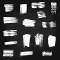 Set of vector white paint brush spots on chalkboard background. Big set of watercolor strokes isolated on black. Grunge Royalty Free Stock Photo