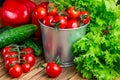 Set of vegetables for salad, cucumbers, bell peppers, fresh red cherry tomatoes on a wooden table top.Top view. Royalty Free Stock Photo