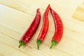 Set of vegetables three red pods of red chili peppers on a wooden background Royalty Free Stock Photo