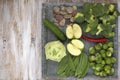 Set of vegetables on white painted plate and wooden background: kohlrabi, cucumber, apple, pepper, brussels sprouts, pea pods, bro Royalty Free Stock Photo