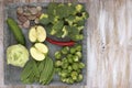 Set of vegetables on white painted plate and wooden background: kohlrabi, cucumber, apple, pepper, brussels sprouts, pea pods, bro Royalty Free Stock Photo