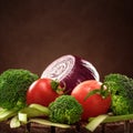 Set of vegetables on wooden stand on brown background. The concept of healthy eating.