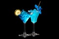 Set of Blue Curacao cocktails garnished with a lime isolated on black background Royalty Free Stock Photo