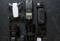 Set of videographer on a black background. Digital camera, memory card, action camera, drone, remote control and camera. Top view