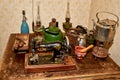 Set of vintage antiques on an old table. kitchenware, lamps, kerosene stove