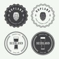 Set of vintage beer and pub logos, labels and emblems with bottles, hops, and wheat Royalty Free Stock Photo