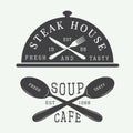 Set of vintage cafe and steak house logo, badge and emblem with spoons, forks and knifes