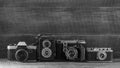 Set of vintage film camera from the times of the USSR on a wooden background, closeup, copy space. Line of old retro cameras. Royalty Free Stock Photo