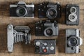 Set of vintage film camera from the times of the USSR on a wooden background, closeup, top view. Line of old retro cameras Royalty Free Stock Photo