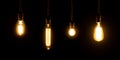 Set of vintage glowing light bulbs on black background.