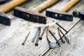 Set of vintage hand construction tools hammers with nails on a wooden background, retro concept Royalty Free Stock Photo