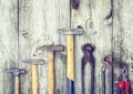 Set of vintage hand construction tools hammers on a wooden background, retro concept Royalty Free Stock Photo