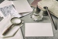 Set of vintage stationery, wooden pen, inkwell, magnifier and envelopes, letters close up. Writing a letter. Memory and Royalty Free Stock Photo