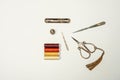A set of vintage style copper scissors, thimble and sewing accessories along with spools of thread of various colors on a plain Royalty Free Stock Photo