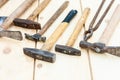 Set of vintage well used hand construction tools for handyman, hammers, on a wooden background Royalty Free Stock Photo